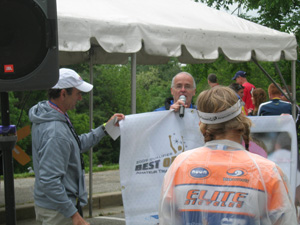 Krista receiving Best of the U.S. banner from Jerry McNeil